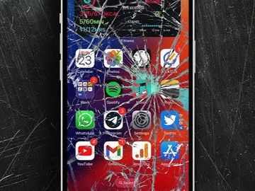 Smartphone with a severely cracked screen displaying app icons.