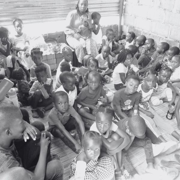 A large group of children sitting closely together indoors.