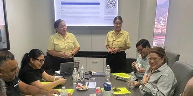 Group in a meeting room discussing.