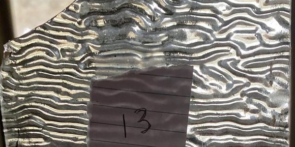 Textured glass with a sticky note labeled '13'.
