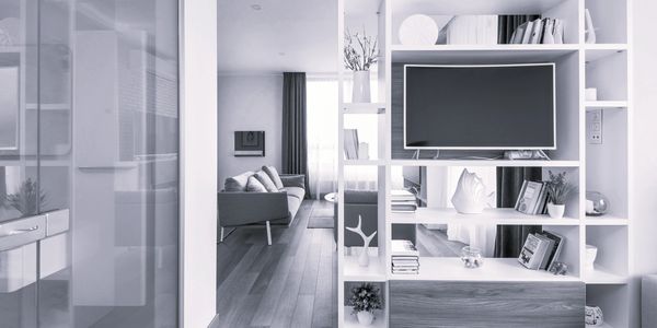 Modern living room with open shelving and a TV.