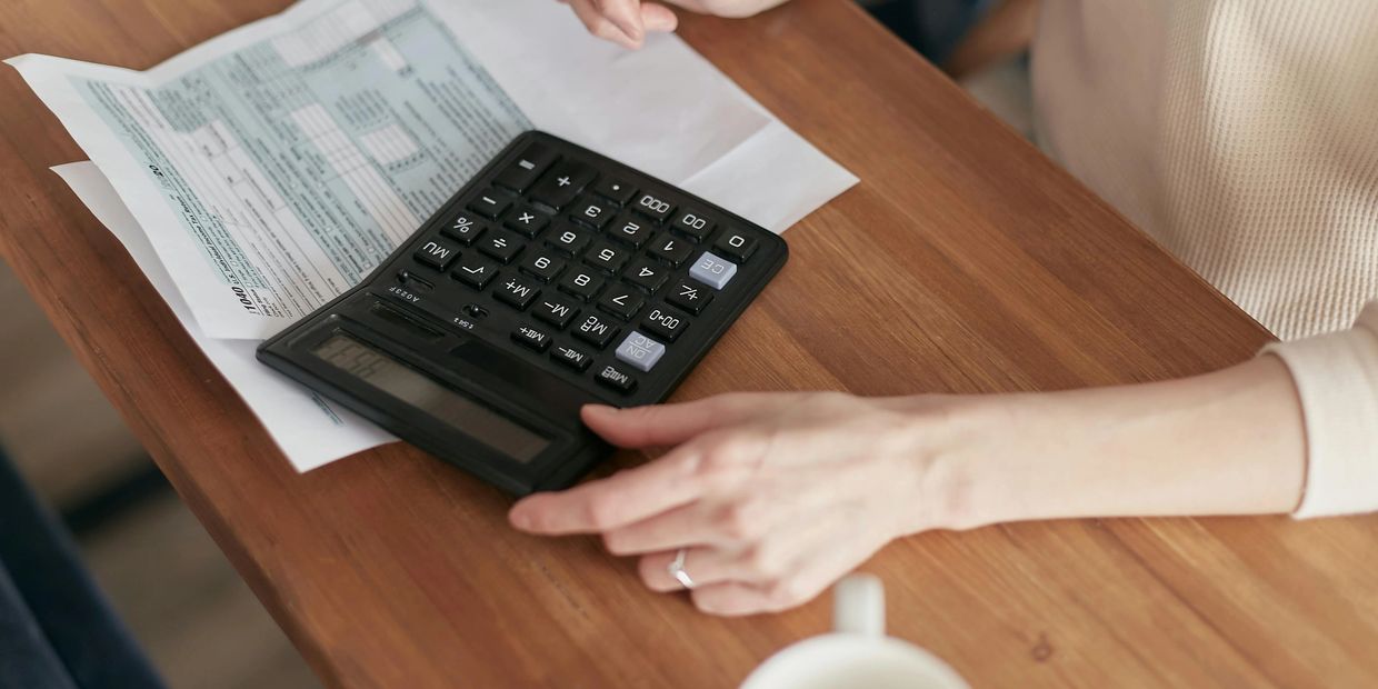 Person with calculator and Paper