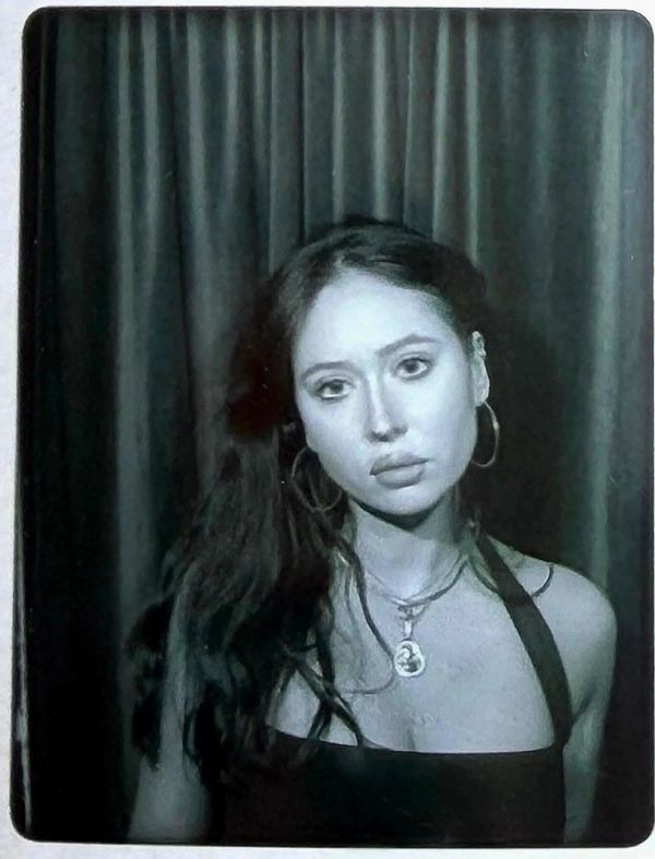 Black and white portrait of a woman with long hair and hoop earrings.