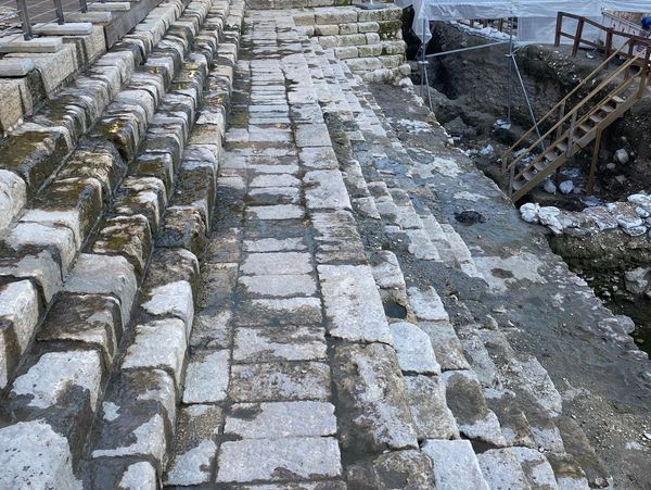 Ancient stone steps at an archeological site with protective coverings.