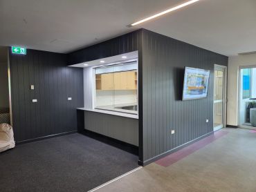 Modern interior with a service window and mounted TV.