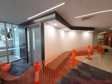 Indoor area with construction barriers and an elevator.