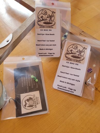 Packaged ice bead rigs with glow beads, handmade in Michigan by Drawn To Wood.