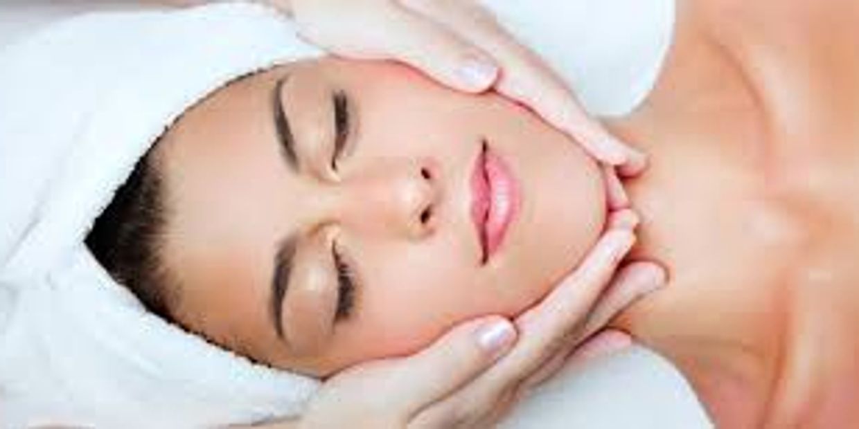 Woman receiving a relaxing facial massage at a spa.