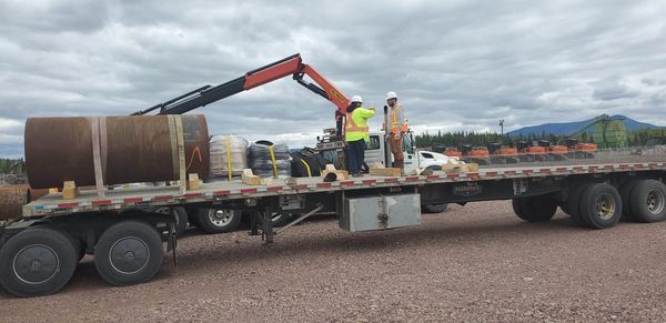 Flatbed shipments secured with chains, binders and straps with proper PPE safety.