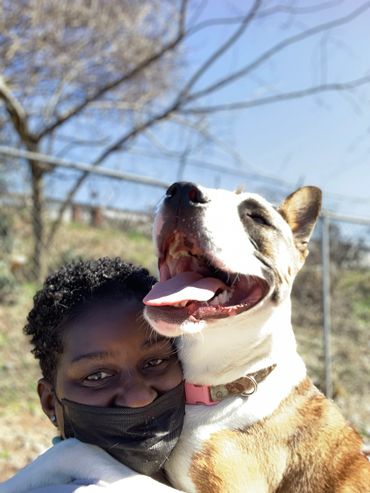 Trainer & dog hugging