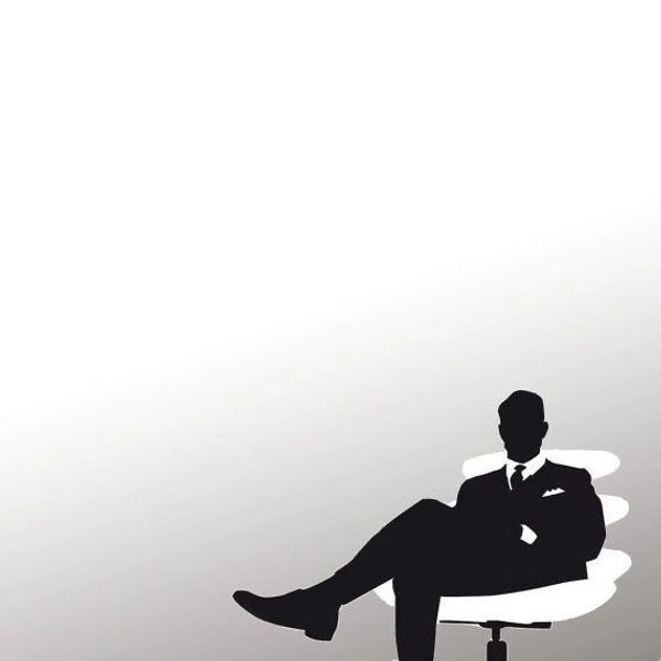 Silhouette of a man sitting confidently in a chair.