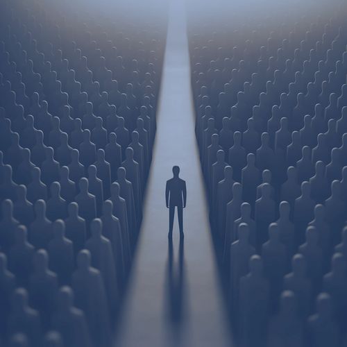 A single figure stands out among a crowd of indistinct silhouettes.