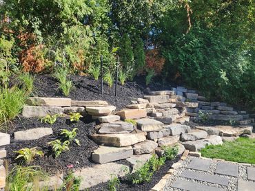 natural stone, retaining wall, walkway, planting, landscaping