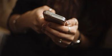 Hands holding cell phone