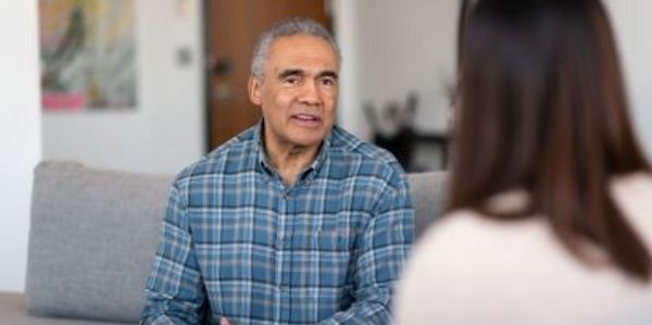 a man talking to woman 