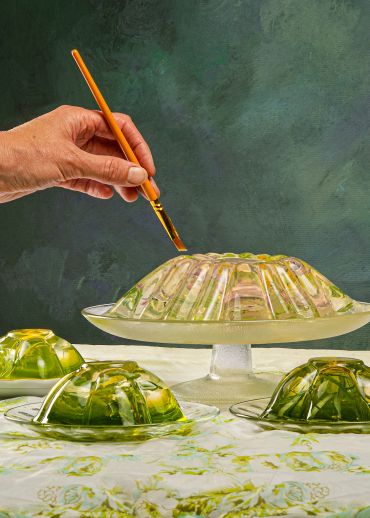 Hand painting a gelatin dessert with a brush.