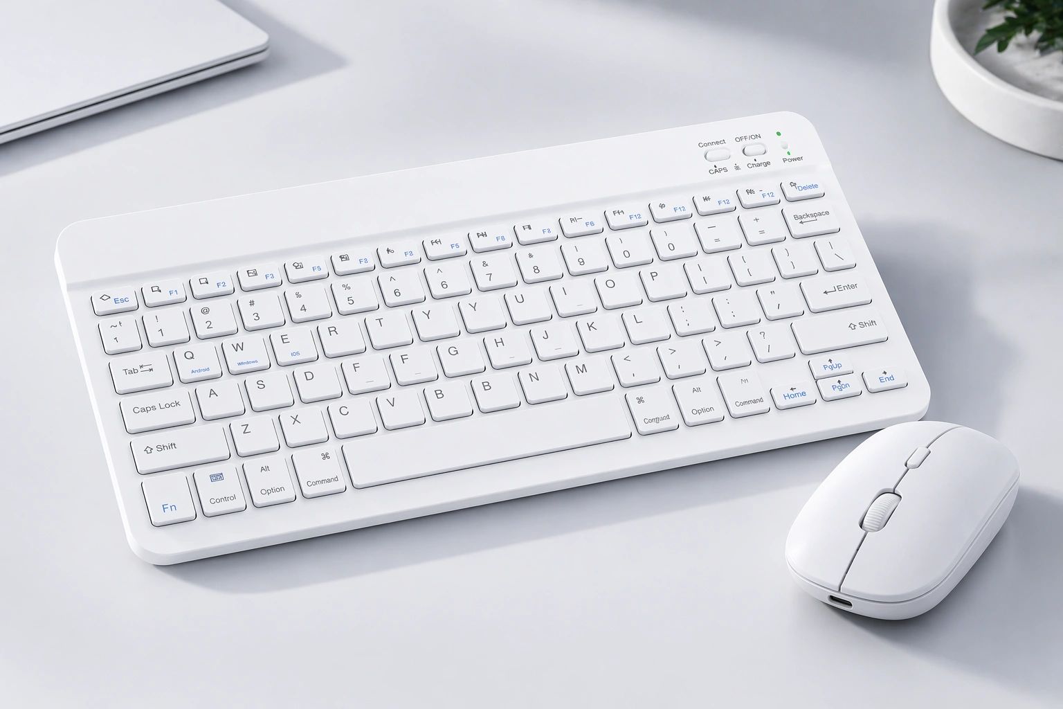 White wireless keyboard and mouse set on a clean desk.