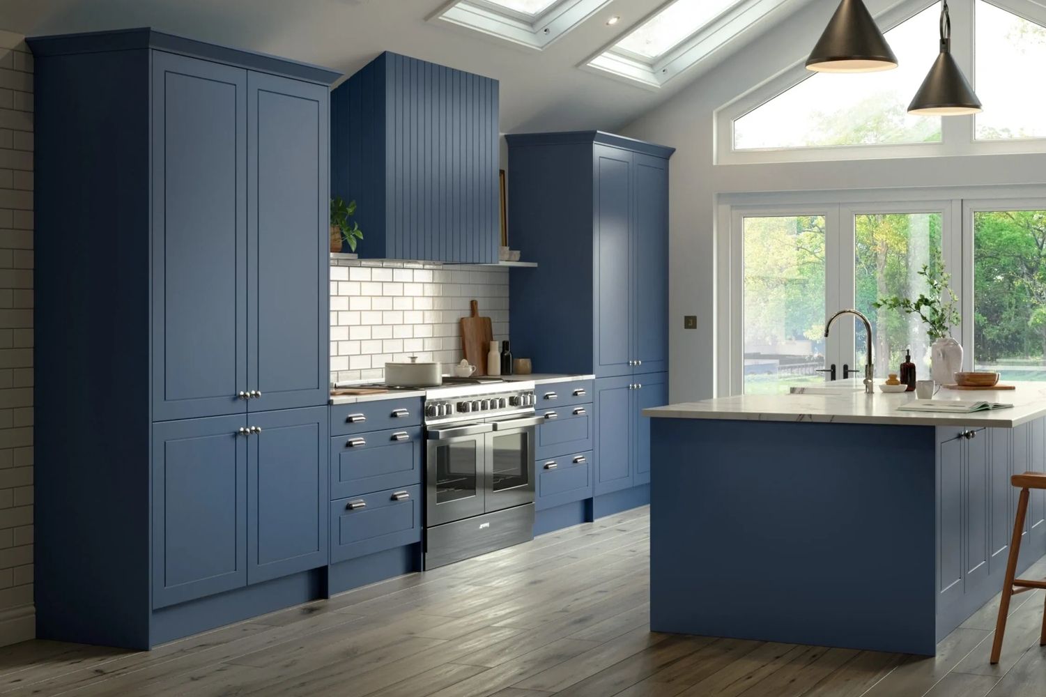 Modern kitchen with blue cabinetry and marble island under pendant lights.