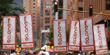Protesters holding Fecode signs in a city street.