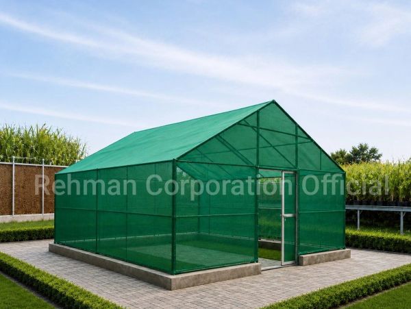 Greenhouse structure with green mesh cover in a garden setting.