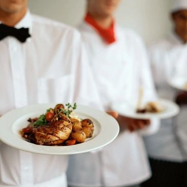 Server holding a meal created by a Personal chef