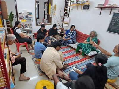 Group of people seated indoors engaging in discussion.
