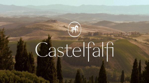 Scenic Tuscan hills with Castelfalfi logo.
