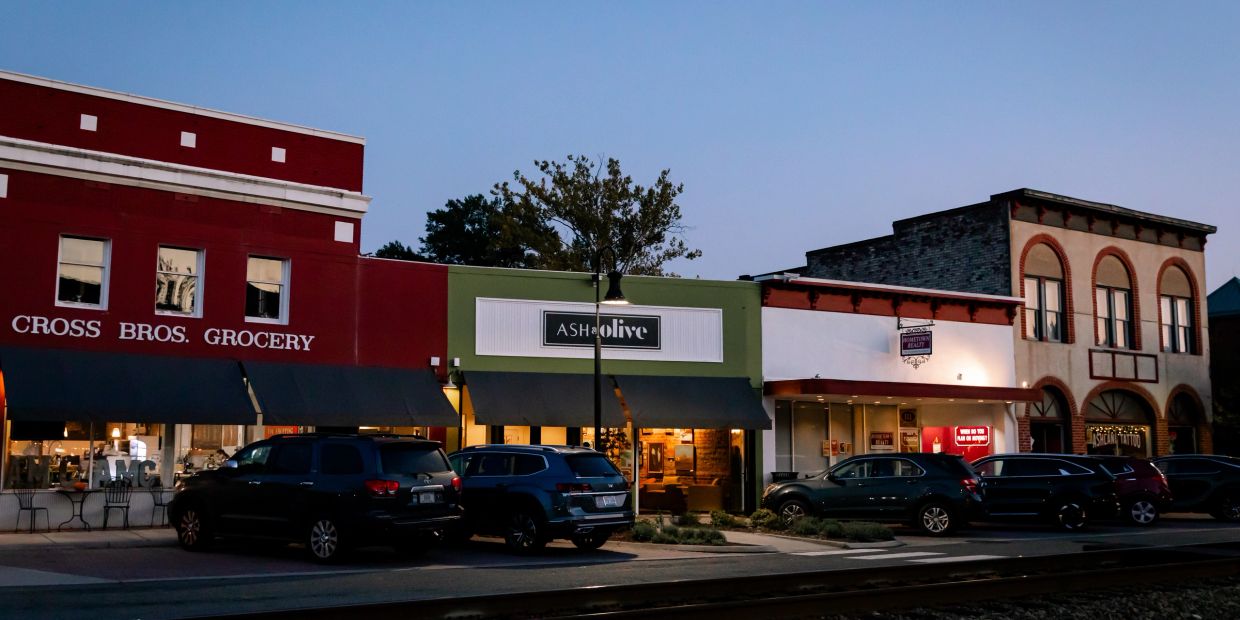 A street view of small shops at dusk.