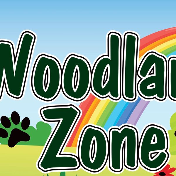 Colorful Woodland Zone sign with rainbow and nature elements.