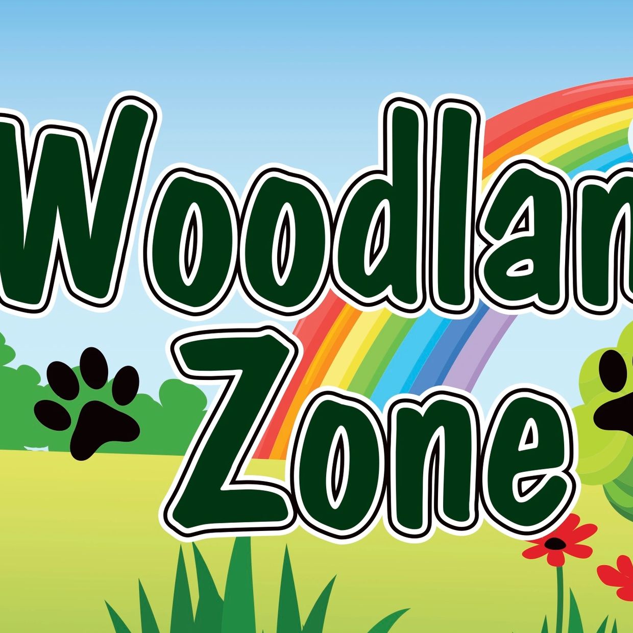 Colorful Woodland Zone sign with rainbow and nature elements.