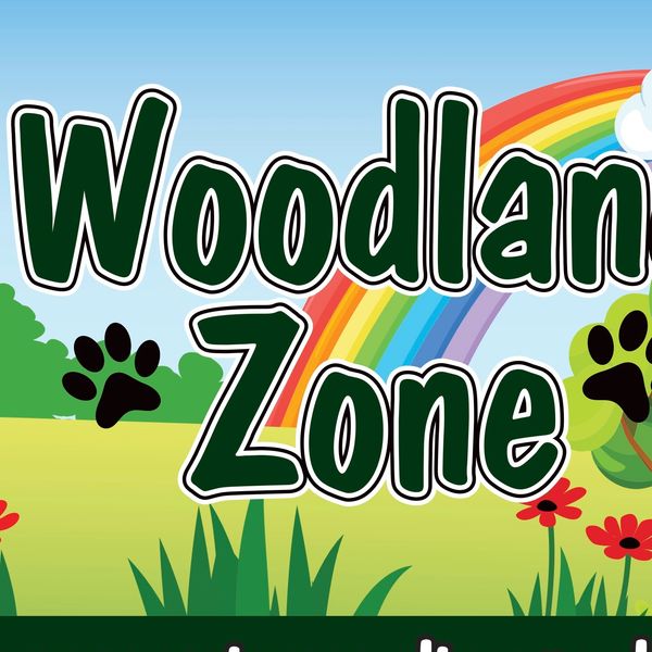 Colorful Woodland Zone sign with rainbow and nature elements.