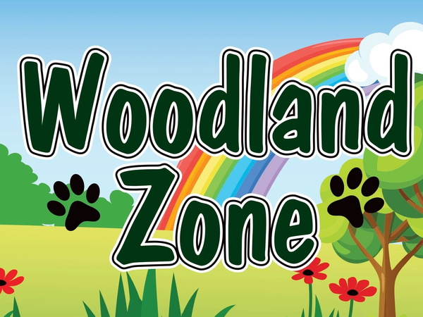 Colorful Woodland Zone sign with rainbow and paw prints.