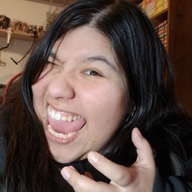 Young woman making a playful face with tongue out and winking.