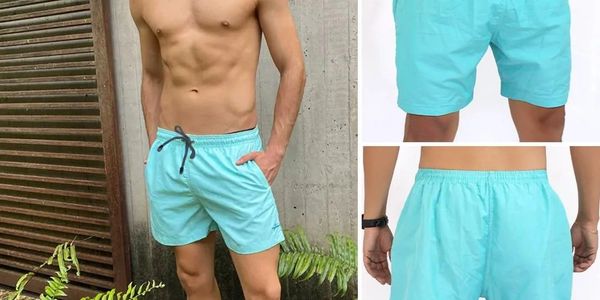 Man modeling swim trunks with hands inside pockets. Front and back image of swim trunks.