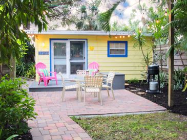 Private deck and patio in the backyard surrounded by topical vegetation