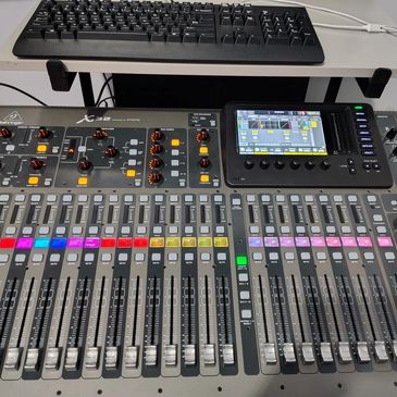 Audio mixing console with keyboard.