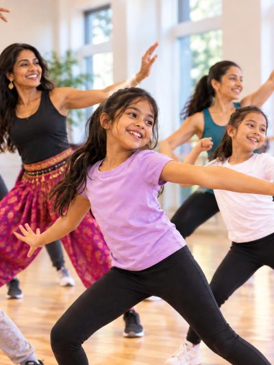 Girls and women dancing happily in a bright room.