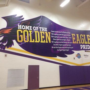 Wall mural featuring the Golden Eagles mascot and school pride slogan.