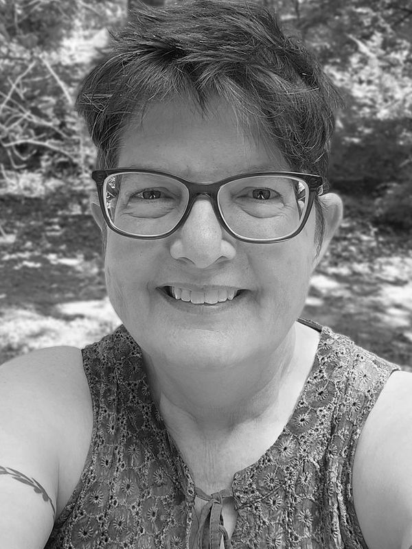 A photograph of Sonya Easterday, a woman with dark hair, glasses, and a friendly smile