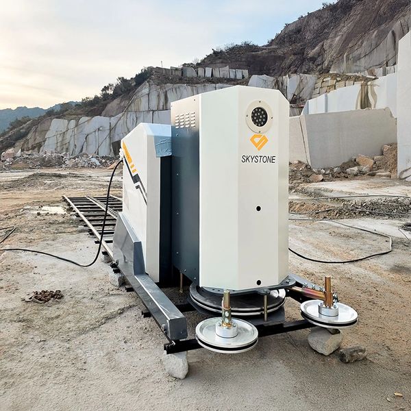 Skystone branded industrial machine on tracks in a rocky quarry.