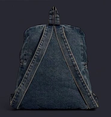Dark denim backpack displayed from the back with adjustable straps.