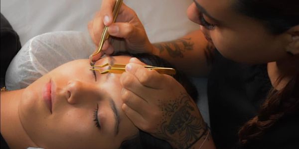 A person getting eyelash extensions.