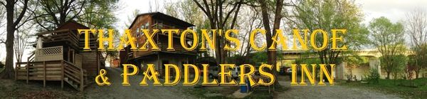 Rustic wooden cabins surrounded by trees and the Main Licking River at Thaxton's Canoe & Paddlers Inn.