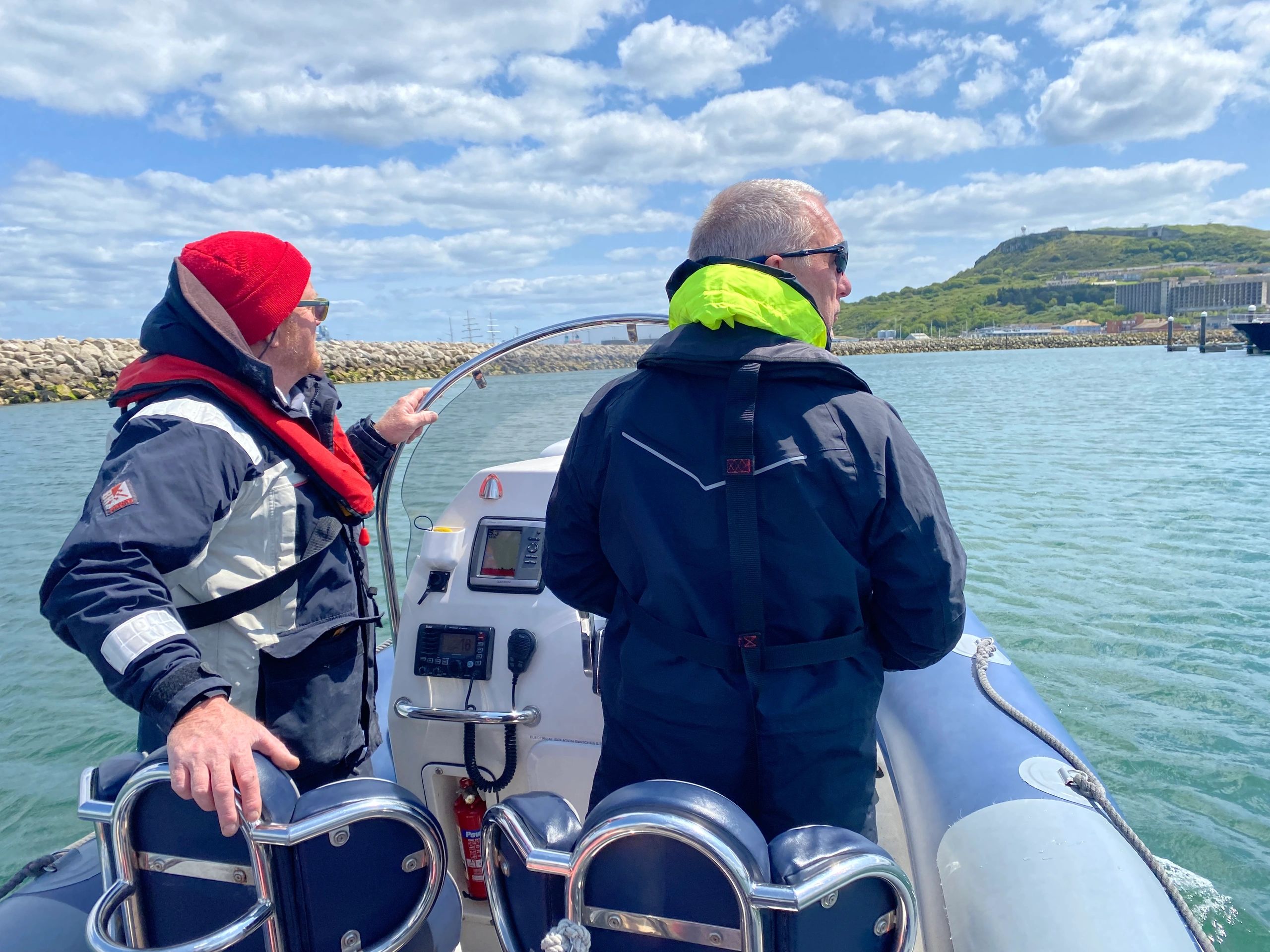 Two people at the helm of a RIB in Portland Harbour during a BSAC Diver Coxswain Preparation Worksho