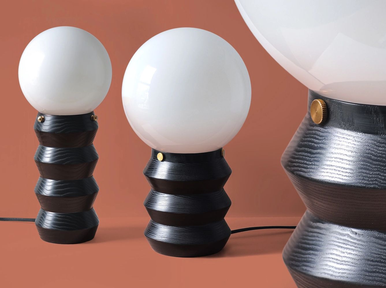 Modern black wooden table lamps with milk glass globes and brass hardware
