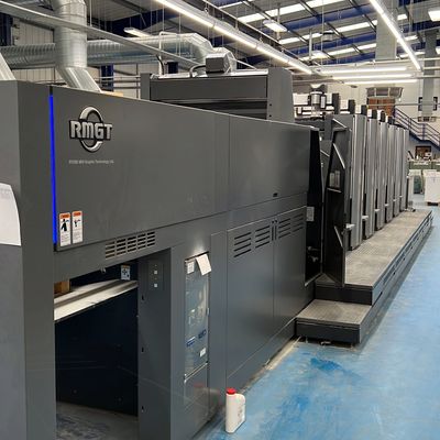 Large industrial RMGT printing press in a factory setting.