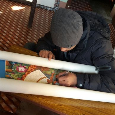 gold polishing in progress of a beautiful Avalokitesvara Thangka/Thanka