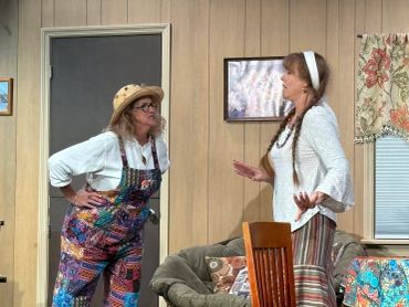 Two women in colorful clothing engaged in intense conversation.