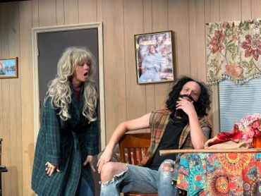 Two people in costumes acting indoors.