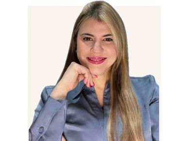 Smiling woman with long blonde hair and blue blouse.